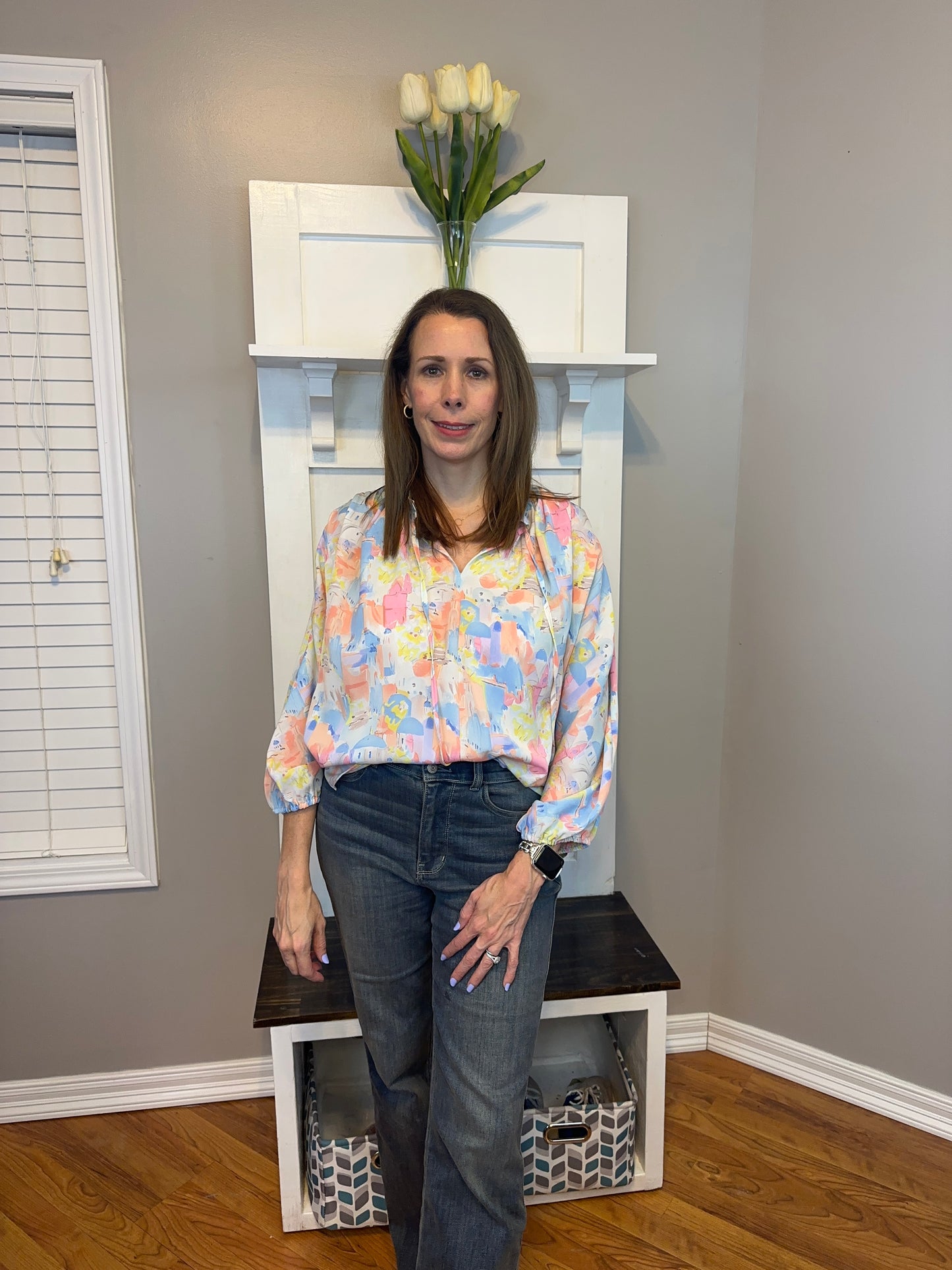 Pink multi printed v-neck 3/4 sleeve top featuring ruffle detail at neck.