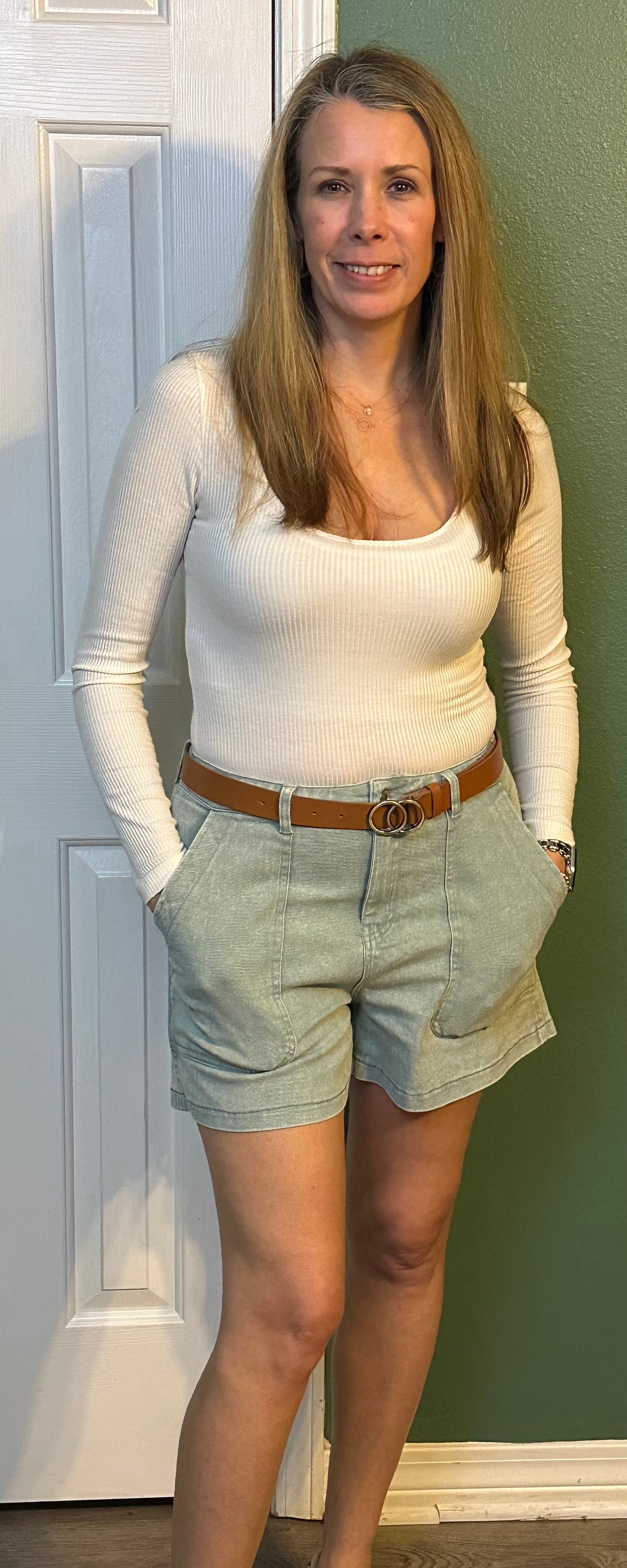 Sea foam Colored high waisted denim shorts featuring pockets at side.