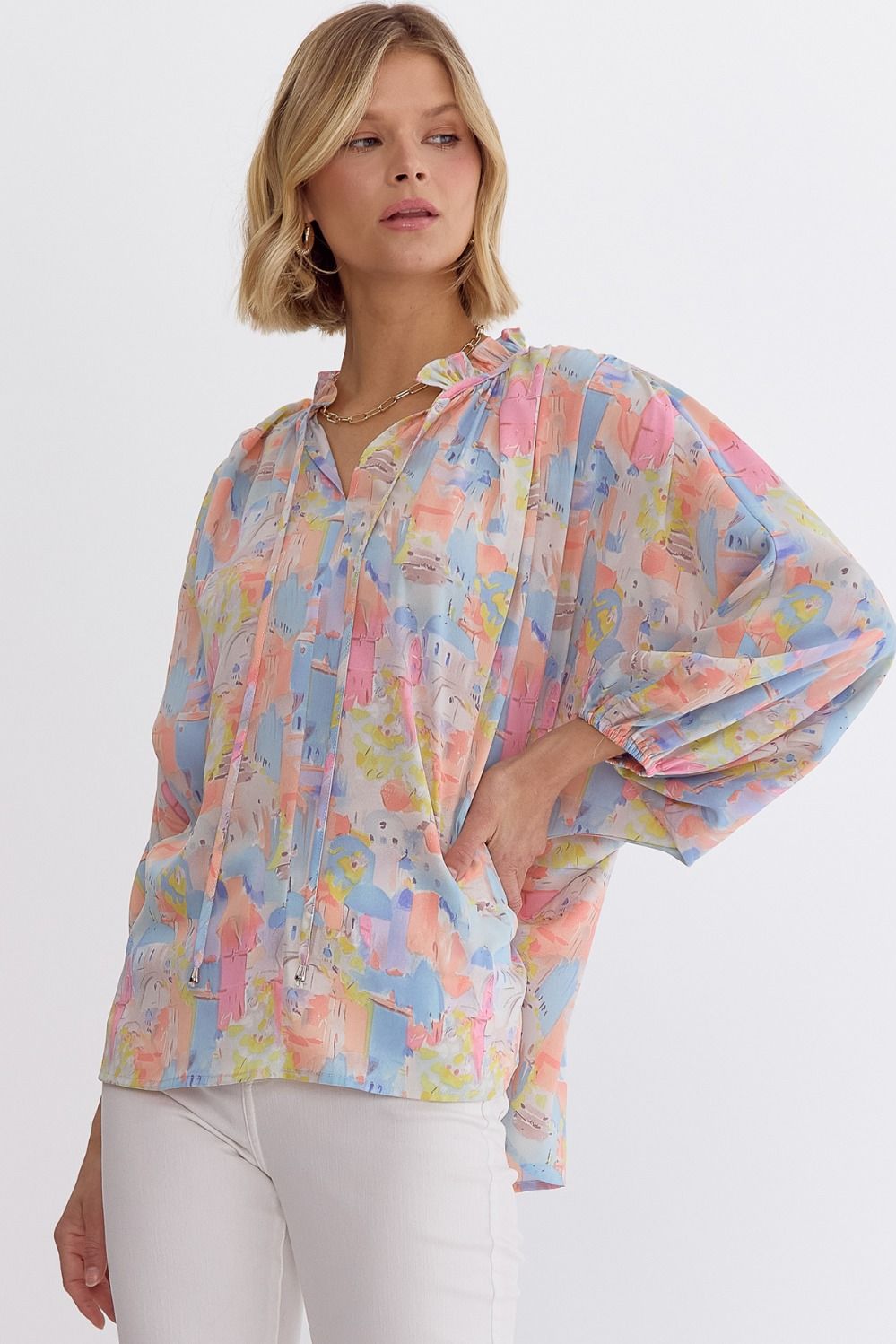 Pink multi printed v-neck 3/4 sleeve top featuring ruffle detail at neck.  image 1