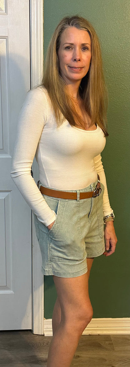 Sea foam Colored high waisted denim shorts featuring pockets at side.