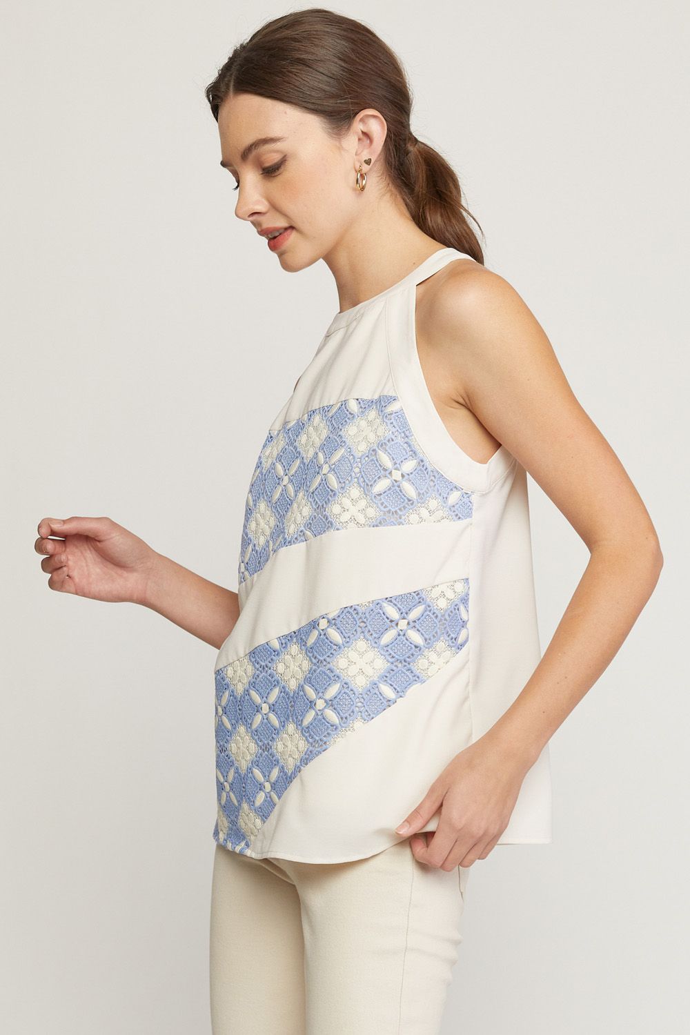 Solid halter neck sleeveless top featuring crochet detail at front. image 1