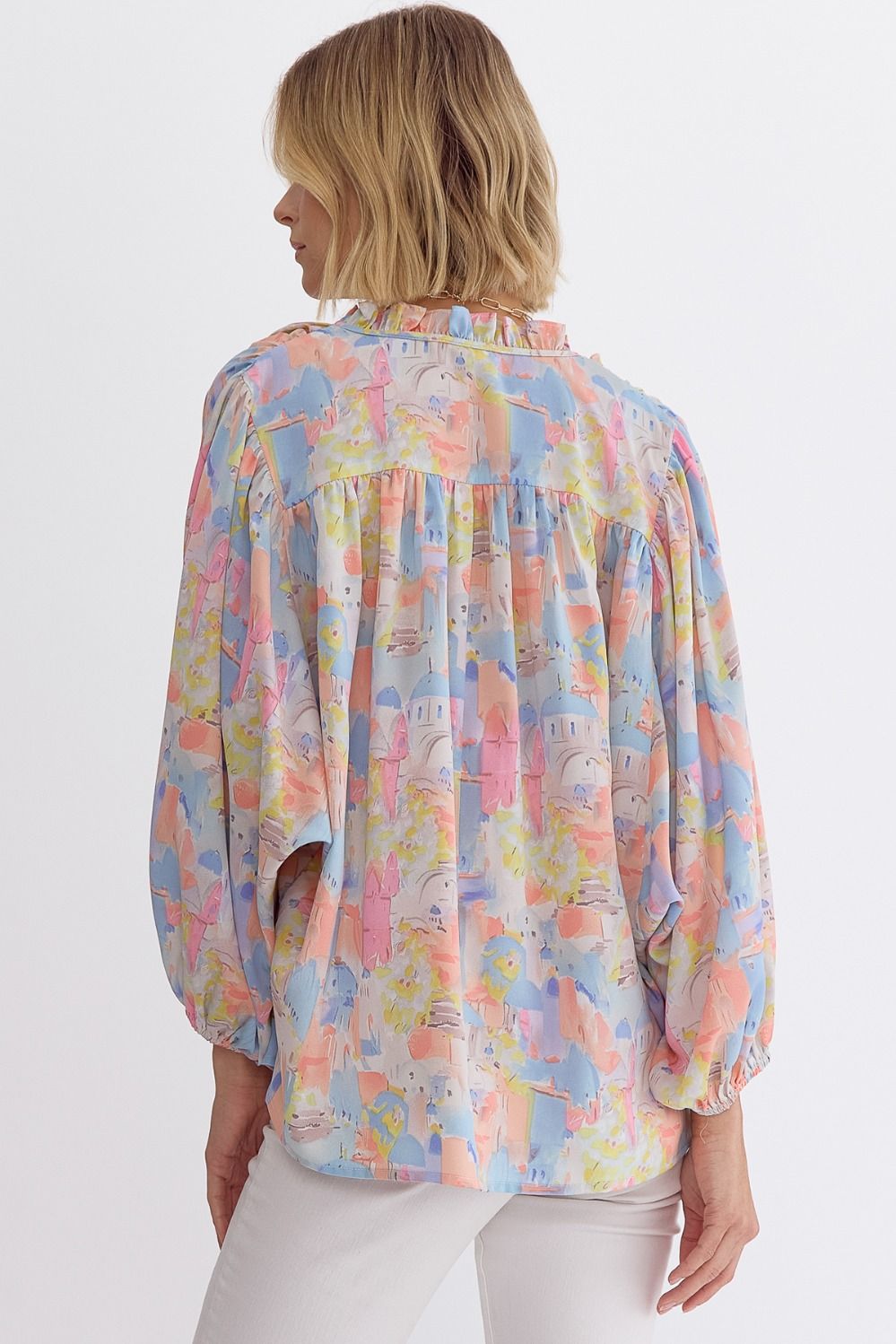 Pink multi printed v-neck 3/4 sleeve top featuring ruffle detail at neck.  image 5