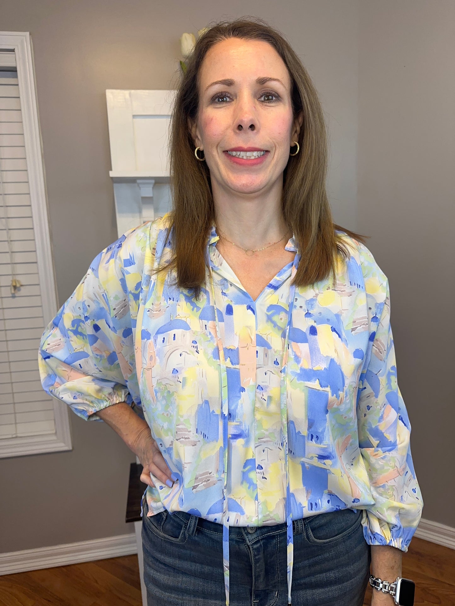 Blue multi printed v-neck 3/4 sleeve top featuring ruffle detail at neck.