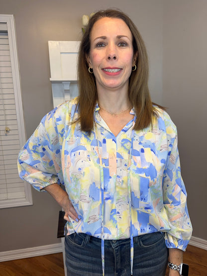 Blue multi printed v-neck 3/4 sleeve top featuring ruffle detail at neck.