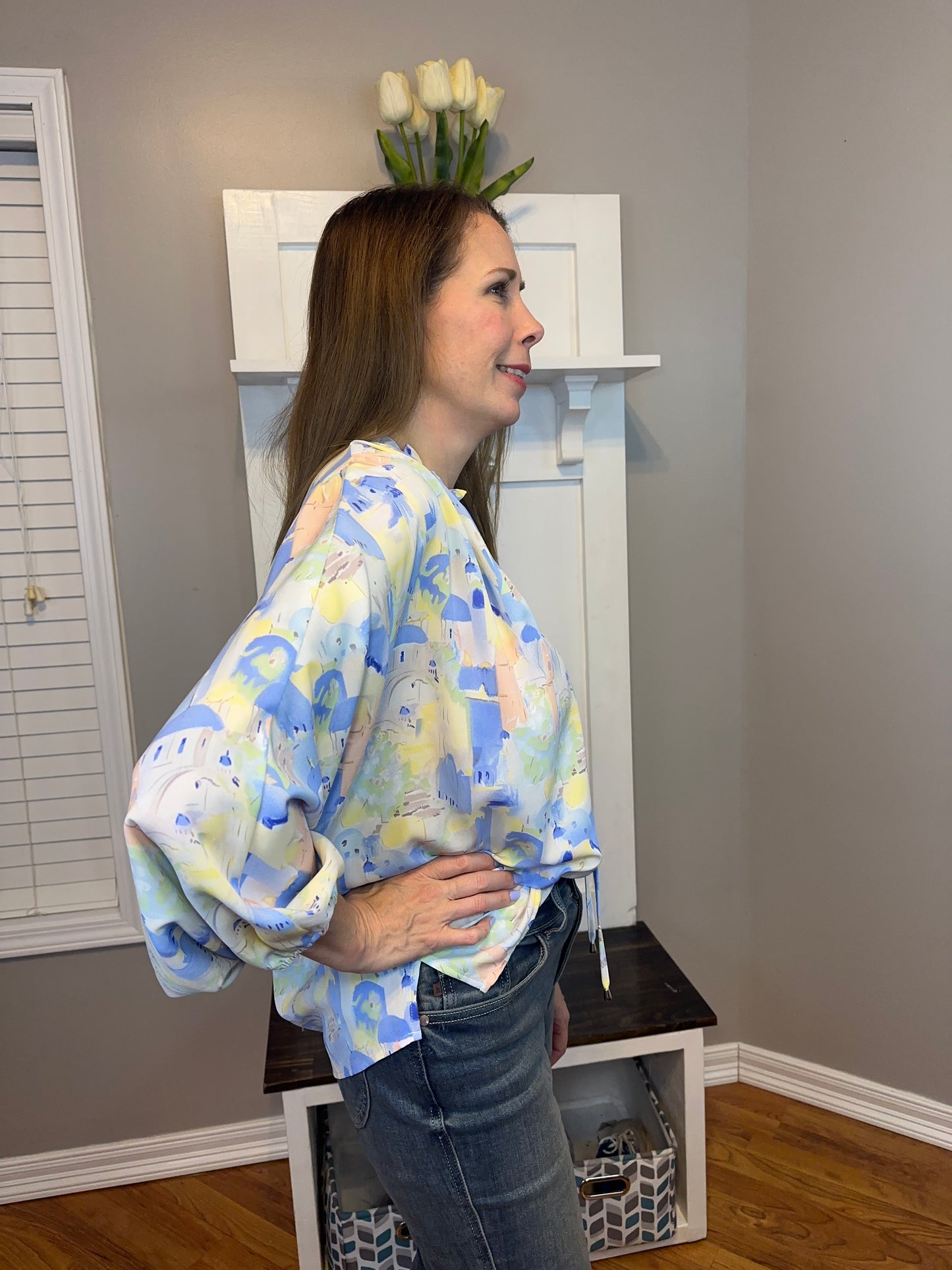 Blue multi printed v-neck 3/4 sleeve top featuring ruffle detail at neck.