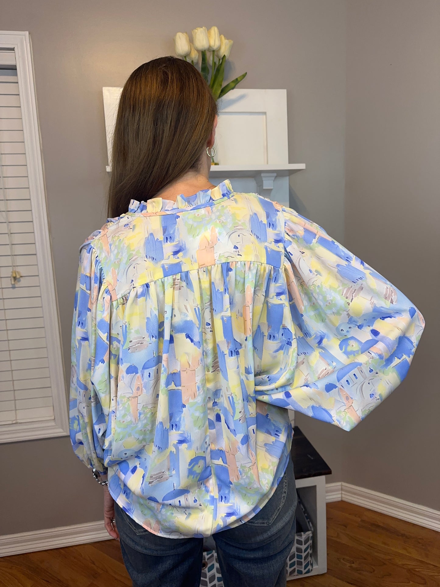 Blue multi printed v-neck 3/4 sleeve top featuring ruffle detail at neck.