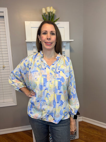 Blue multi printed v-neck 3/4 sleeve top featuring ruffle detail at neck.