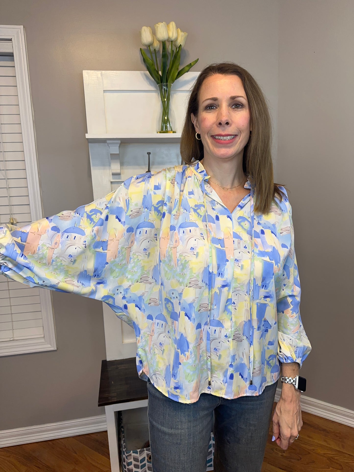 Blue multi printed v-neck 3/4 sleeve top featuring ruffle detail at neck.