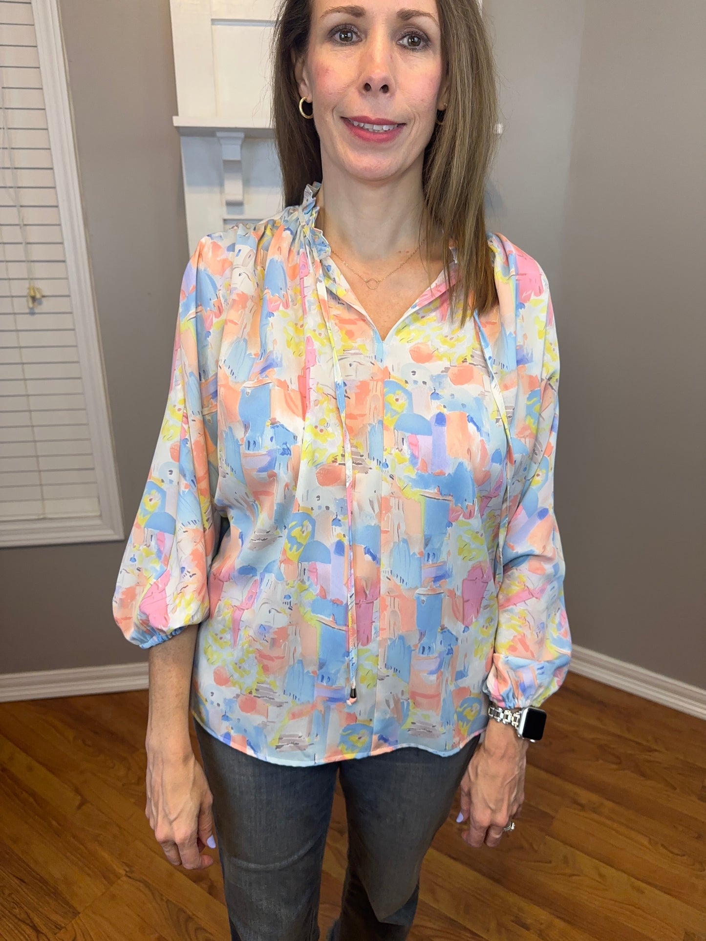 Pink multi printed v-neck 3/4 sleeve top featuring ruffle detail at neck.