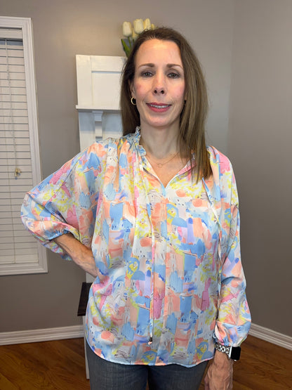 Pink multi printed v-neck 3/4 sleeve top featuring ruffle detail at neck.
