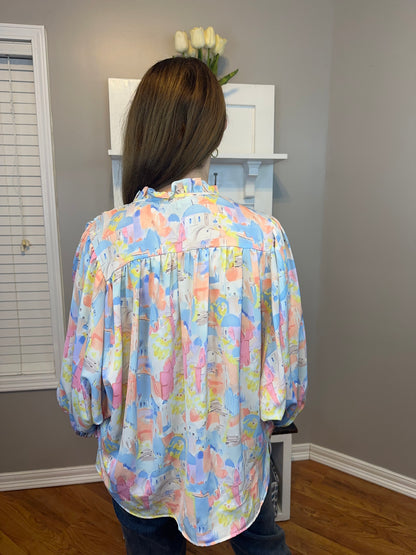 Pink multi printed v-neck 3/4 sleeve top featuring ruffle detail at neck.