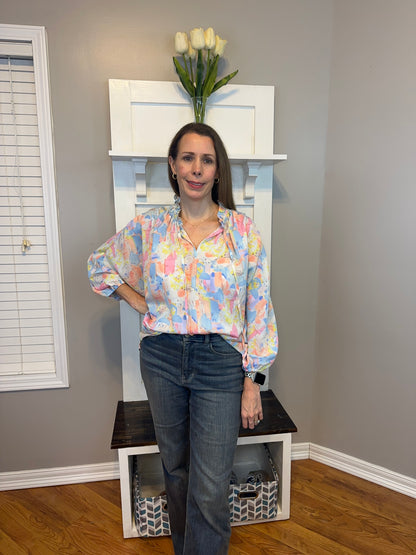 Pink multi printed v-neck 3/4 sleeve top featuring ruffle detail at neck.
