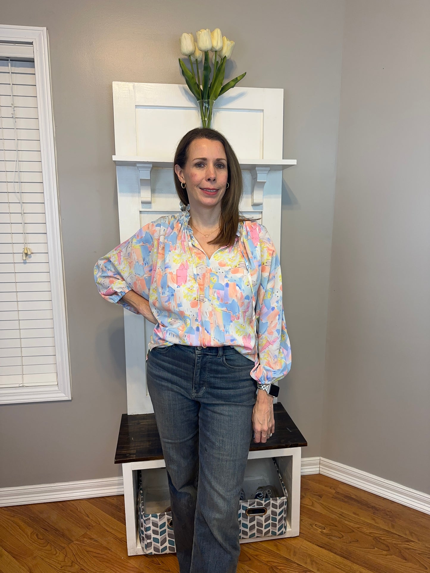 Pink multi printed v-neck 3/4 sleeve top featuring ruffle detail at neck.