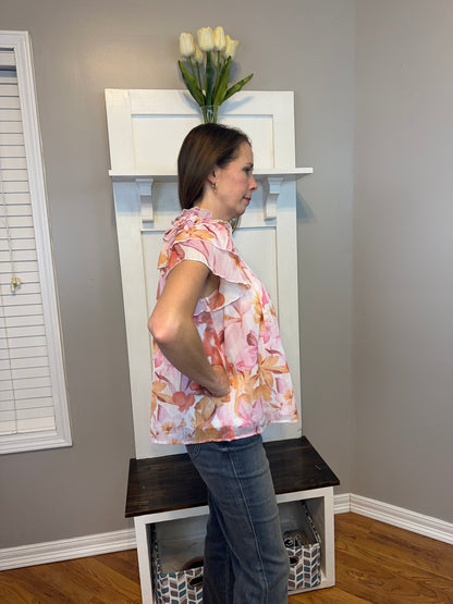 Floral print v-neck ruffle sleeve top featuring self tie at front neck.