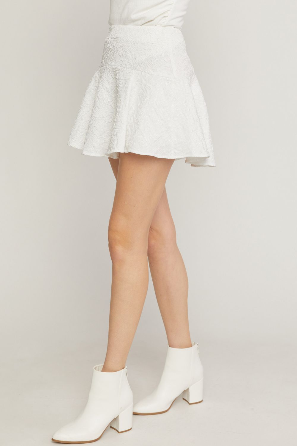 White solid textured flare mini skirt featuring inset shorts. image 1