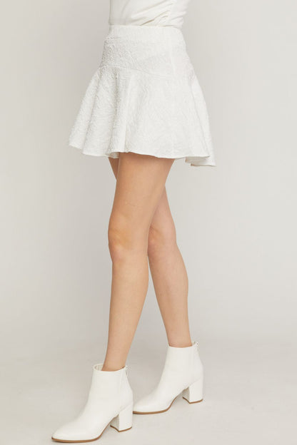 White solid textured flare mini skirt featuring inset shorts. image 1
