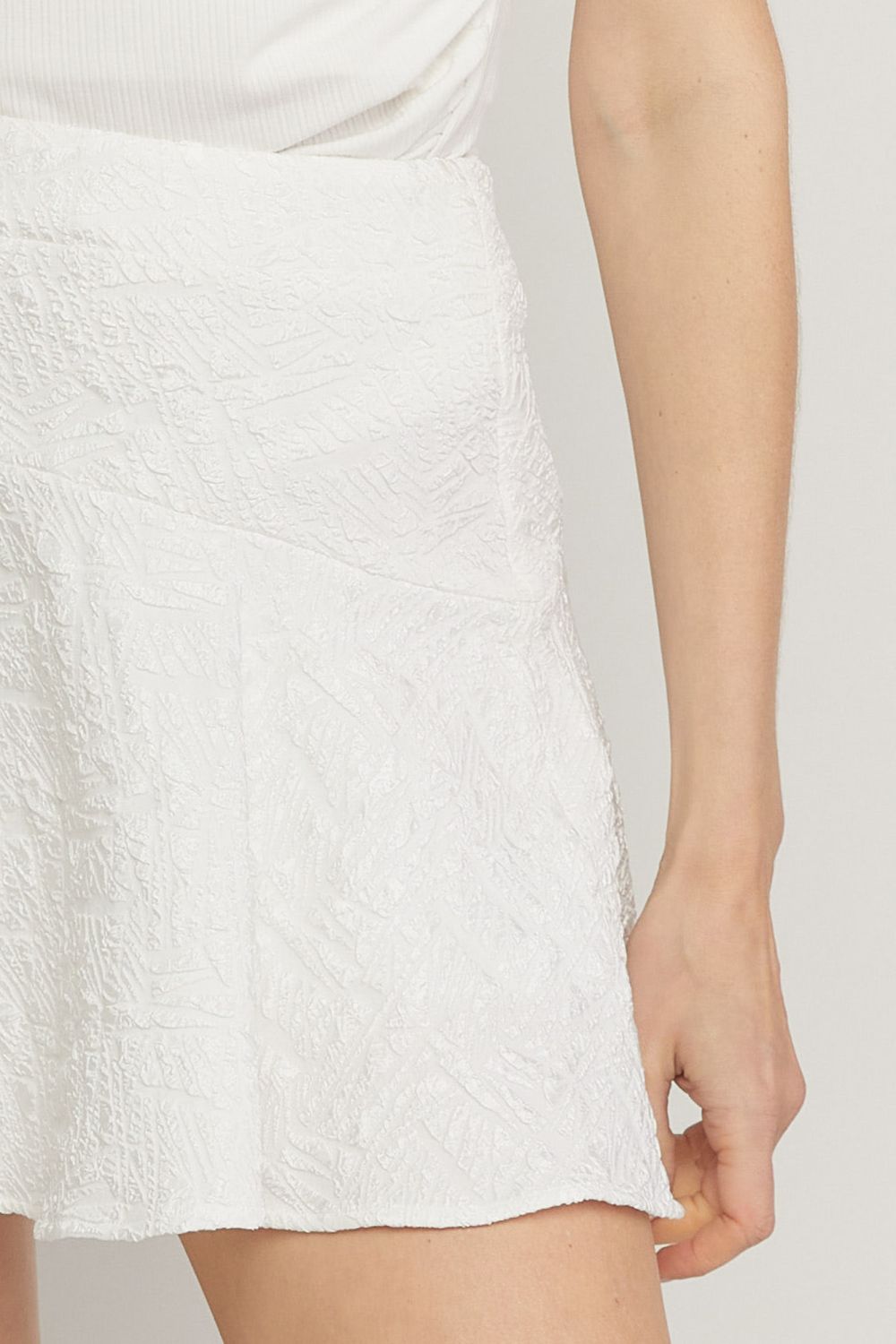 White solid textured flare mini skirt featuring inset shorts. image 4