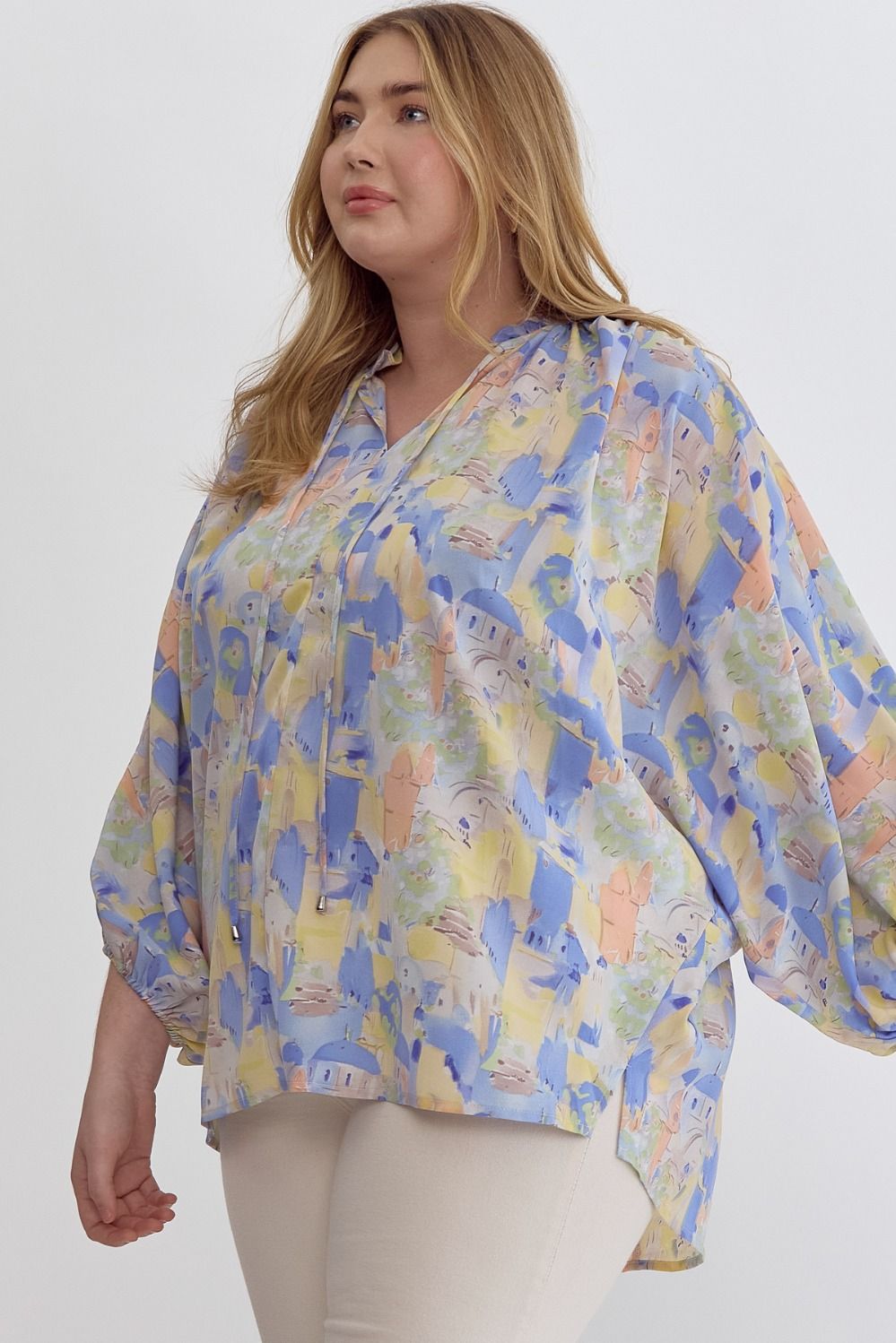 Blue multi printed v-neck 3/4 sleeve top featuring ruffle detail at neck.  image 1