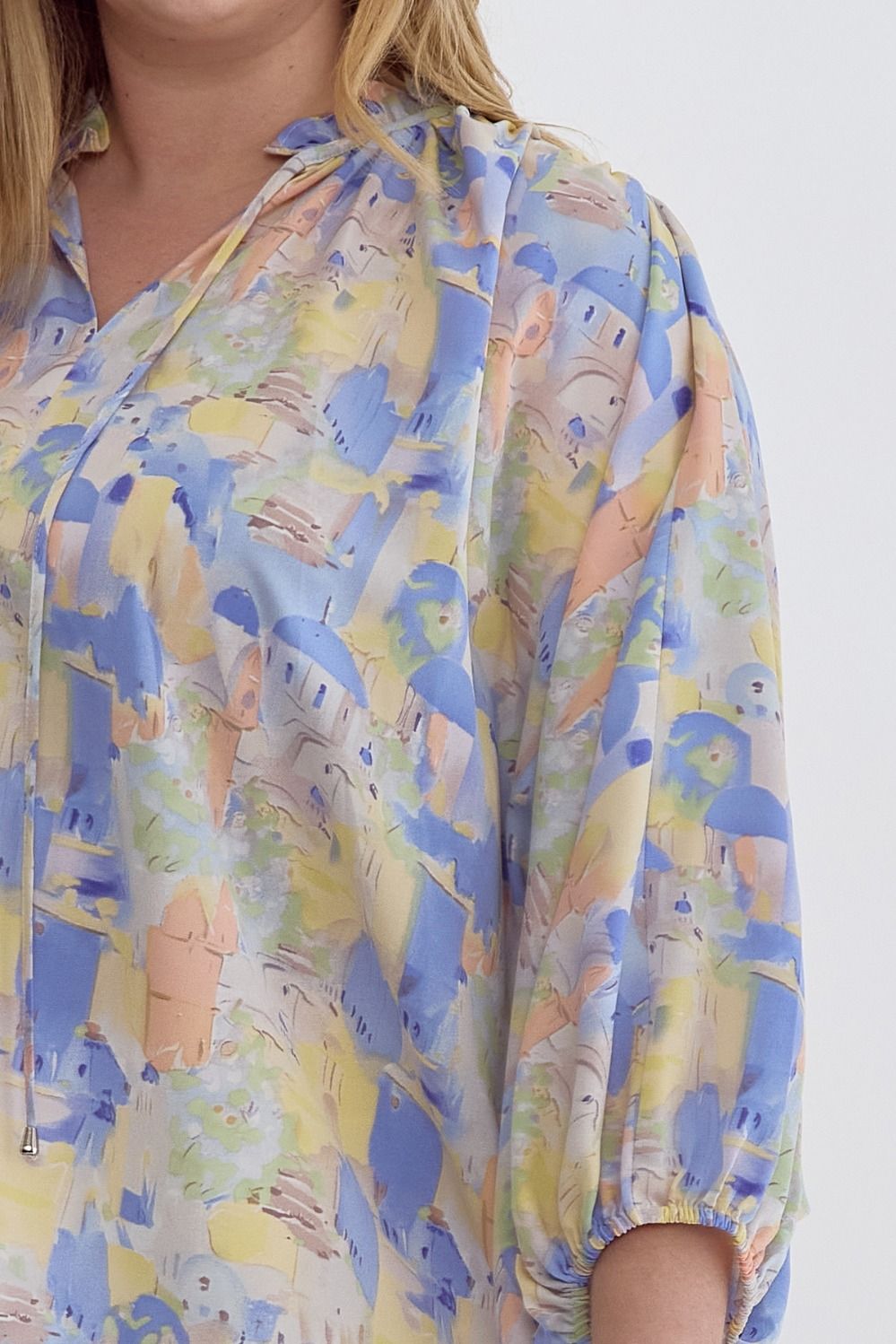 Blue multi printed v-neck 3/4 sleeve top featuring ruffle detail at neck.  image 5