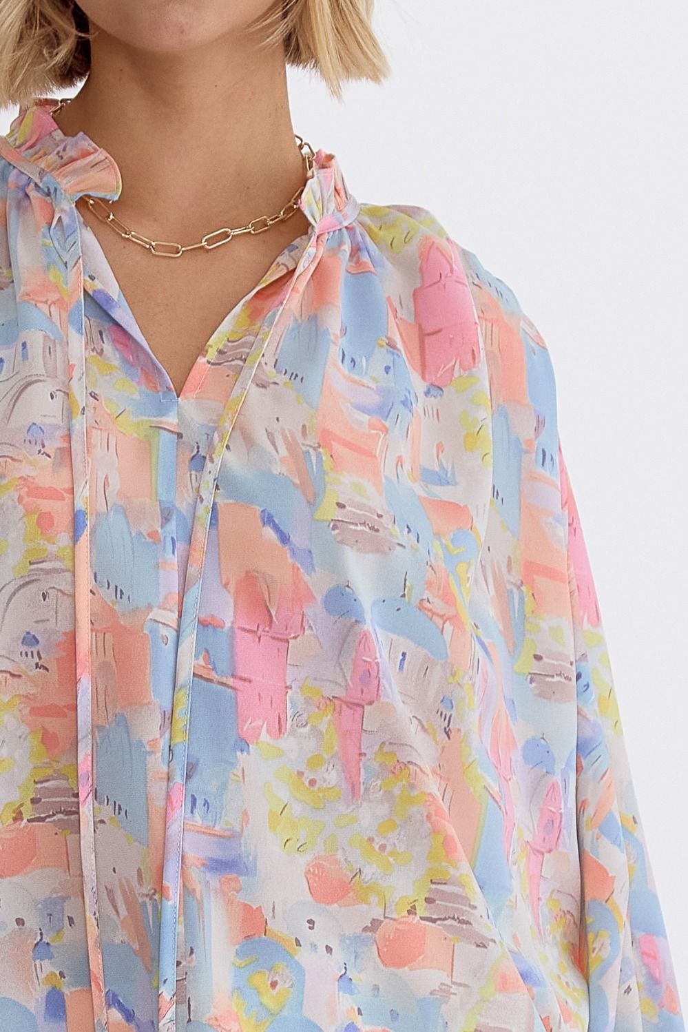 Pink multi printed v-neck 3/4 sleeve top featuring ruffle detail at neck.  image 3